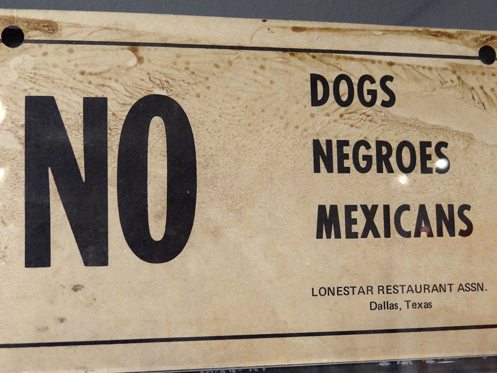 Sign stating no dogs, negroes, or mexicans