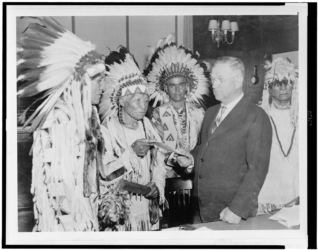 Representatives of the Confederated Bitteroot Salish, Kootenai, and Pend d'Oreilles peopes of Montana's Flathead Reservation meet with Ickes to mark the occasion to honor their new self-determination