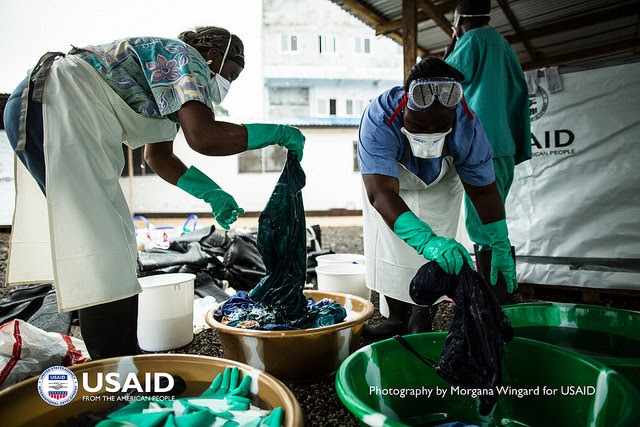 U.S. Aid workers washing clothing